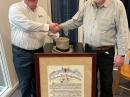 ARRL CEO David Minster, NA2AA (left) greets Bruce Godley Littlefield, grandson of Paul Godley, 2ZE, with the original ARRL resolution recognizing Paul Godley for the success of the December 1921 Transatlantic Tests, and the hand-painted derby hat won by ARRL Secretary K. B. Warner, who had bet that US signals would be heard in Europe during the tests. Littlefield presented ARRL with a copy of the resolution.